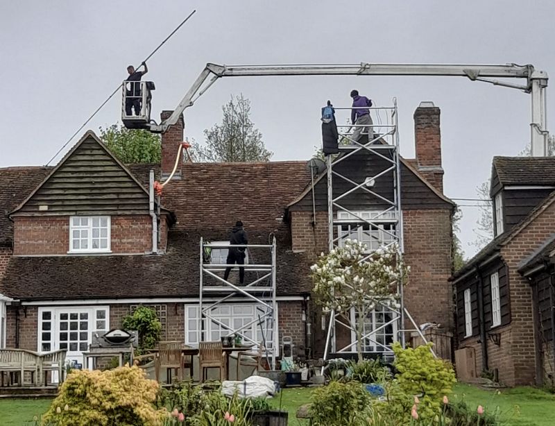 The Moss Cleaners using cherry picker and scaffolding to clean roof safely and professionally in Atherstone, Warwickshire